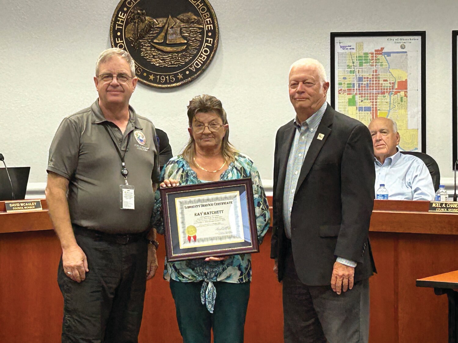 Kay Matchett was honored for five years of service to the city at the recent city council meeting. Pictured are Public Works director David Allen (left), Matchett and Mayor Dowling Watford.